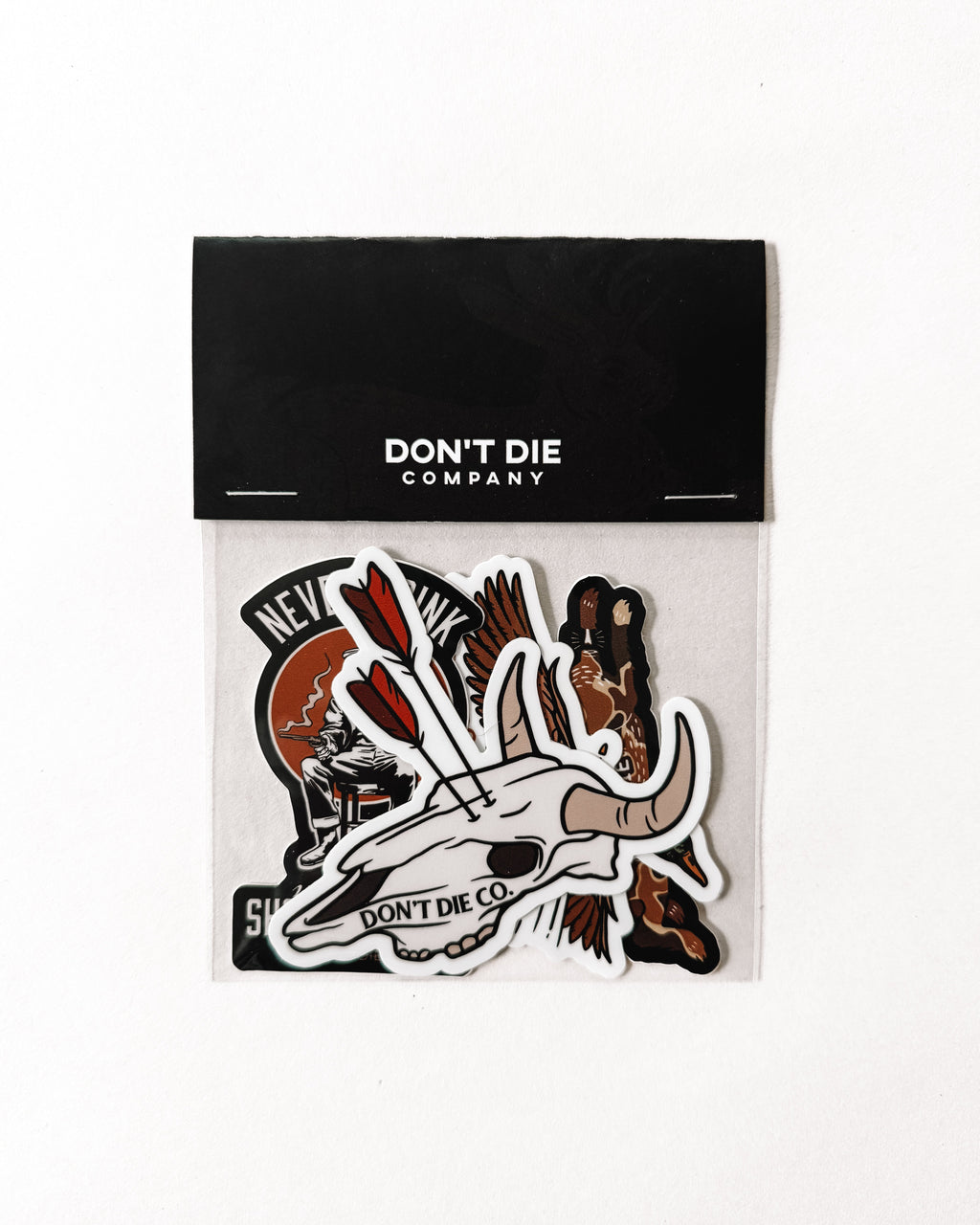 Packaged product with 'Don't Die Company' branding and stickers on a white background